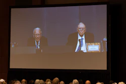 Shareholders watch Warren Buffett and Charlie Munger from the overflow room during the Berkshire Hathaway annual meeting on Saturday, May 6, 2023, in Omaha, Neb.