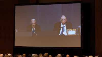 Shareholders watch Warren Buffett and Charlie Munger from the overflow room during the Berkshire Hathaway annual meeting on Saturday, May 6, 2023, in Omaha, Neb.