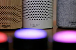 Amazon Echo and Echo Plus devices, behind, sit near illuminated Echo Button devices during an event by the company in Seattle, Sept. 27, 2017.