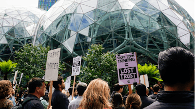 Amazon corporate workers hold picket signs in front of the Amazon Spheres, Seattle, May 31, 2023.