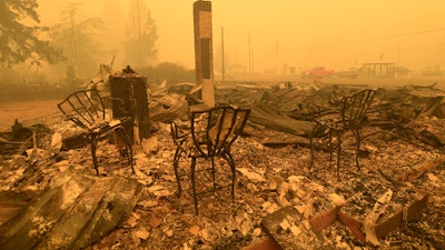 Chairs stand at the Gates Post office in the aftermath of a fire in Gates, Ore., Sept 9, 2020.
