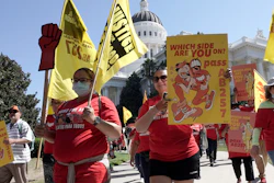 Fast food workers and their supporters march past the California state Capitol in Sacramento, Tuesday, Aug. 16, 2022.