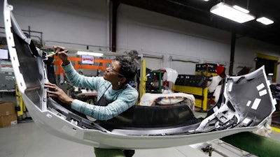 Mary Skinner inspects the rear end of a General Motors Chevrolet Cruze at Jamestown Industries in Youngstown, Ohio on Nov. 28, 2018.