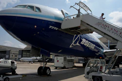 A man walks down the steps of the Boeing 777X airplane during the Paris Air Show in Le Bourget, north of Paris, France, Monday, June 19, 2023. Airlines are facing increasing pressure to cut their climate-changing emissions. That made sustainable aviation fuel a hot topic this week at the Paris Air Show, a major industry event. Sustainable fuel made from food waste or plant material is aviation's best hope for reducing emissions in the next couple of decades.