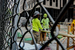 Construction workers work with rebar at a site in New York, June 6, 2023.