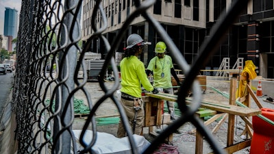 Construction workers work with rebar at a site in New York, June 6, 2023.