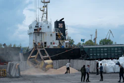 Workers load grain at a port in Izmail, Ukraine, April 26, 2023.