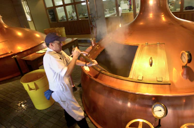 In this 2004 file photo, a worker performs his duties at the Anchor Brewing Co. in San Francisco.