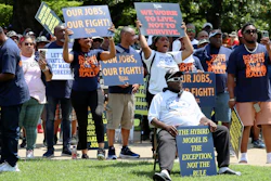 Workers hold signs supporting labor organizers at a rally in Columbia, S.C., July 12, 2023.