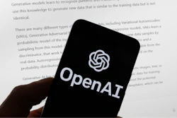 The OpenAI logo is seen on a mobile phone in front of a computer screen displaying output from ChatGPT, March 21, 2023, in Boston.