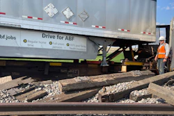 In this photo provided by Hill County Disaster and Emergency Services, a railroad worker stands among derailed freight cars from a BNSF Railway train that derailed east of Havre, Montana on Friday, July 21, 2023.