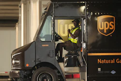 A UPS driver puts his seat belt on before driving off during a rally in downtown Los Angeles, July 19, 2023.
