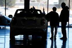 Shoppers consider a 2022 Cooper convertible on display in a Mini dealership in Highlands Ranch, Colo., on Friday, Feb. 18, 2022.