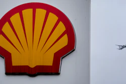 An aircraft passes a sign at a shell petrol station in London, Thursday, Feb. 2, 2023.
