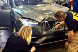 In this photo provided by the National Transportation Safety Board, investigators examine a driverless Uber SUV, March 20, 2018, that fatally struck a woman in Tempe, Ariz.