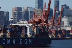 Gantry cranes sit idle as a container ship is docked at port during a work stoppage, Vancouver, July 19, 2023.