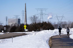 People walk on a trail at the Montissippi County Park near the Xcel Energy Monticello Generating Plant, a nuclear power plant, in Monticello, Minn., on Friday, March 24, 2023.
