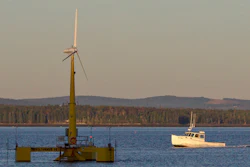 A lobster boat passes the country's first floating wind turbine off the coast of Castine, Maine, Sept. 20, 2013.