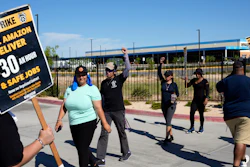 Workers picket outside an Amazon distribution center in Palmdale, Calif., July 24, 2023.