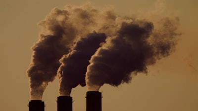 Emissions rise from the smokestacks at the Jeffrey Energy Center coal power plant as the suns sets, near Emmett, Kan., Sept. 18, 2021.
