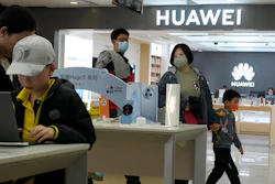 People visit a Huawei franchise store in Beijing on April 28, 2023. Chinese tech giant Huawei on Friday, Aug. 11, reported its revenue rose 3% over a year earlier in the first half of 2023 and its profit margin widened despite sanctions that block access to U.S. processor chips and other technology.