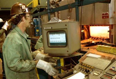Bob Simmons monitors the controls for a furnace and rolling machine at the US Steel research and development facility in Monroeville, Pa., on June 6, 2005. With two bidders revealed in a matter of days and more in the wings, United States Steel Corp. seems poised to be purchased by a competitor sooner than later.