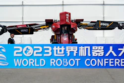 Workers demonstrate a giant robot at the annual World Robot Conference at the Beijing Etrong International Exhibition and Convention Center, Wednesday, Aug. 16, 2023.