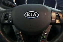 The Kia logo brands a steering wheel inside of a Kia car dealership in Elmhurst, Ill., Oct. 5, 2012.