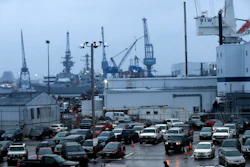 A shipyard worker, below center, walks to his car at the end of a workday at Bath Iron Works in Bath, Maine, Tuesday, Jan. 3, 2017.