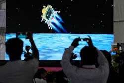 Journalists film the live telecast of spacecraft Chandrayaan-3 landing on the moon at ISRO's Telemetry, Tracking and Command Network facility in Bengaluru, India, Wednesday, Aug. 23, 2023.