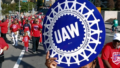 United Auto Workers members walk in the Labor Day parade in Detroit, Sept. 2, 2019.