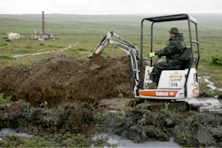 A worker with the Pebble Mine project digs in the Bristol Bay region of Alaska near the village of Iliamma, Alaska, July 13, 2007.