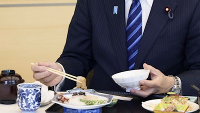 Japanese Prime Minister Fumio Kishida eats seafood from Fukushima prefecture in the prime minister's office, Tokyo, Aug. 30, 2023.