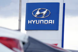 The Hyundai company logo hangs over a long row of cars at a car dealership in Centennial, Colo., Sunday, Dec. 20, 2020.