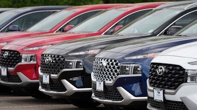 A line of 2022 Santa Fe SUV's sit outside a Hyundai dealership Sunday, Sept. 12, 2021, in Littleton, Colo.