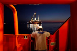 Wilson Ruiz, a crew member of the Joe Griffin, looks out at the oil slick at the site of the BP Deepwater Horizon offshore oil rig collapse in the Gulf of Mexico on May 6, 2010.