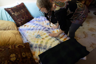 Cathy Jonas, owner of Epic Healing Eugene, Oregon’s first licensed psilocybin service center, adjusts a bed that can be used by clients Friday, Aug. 4, 2023, in Eugene, Ore.
