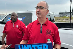 United Auto Workers President Shawn Fain holds up a sign at a union rally held near a Stellantis factory Wednesday, Aug. 23, 2023, in Detroit.