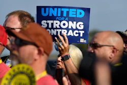 A member holds up a sign at a rally by United Auto Workers Local 863 in Louisville, Ky., on Aug. 24, 2023.