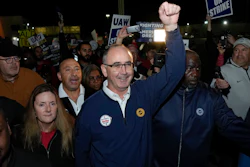 United Auto Workers President Shawn Fain walks with union members striking at Ford's Michigan Assembly Plant in Wayne, Mich., early Friday, Sept. 15, 2023.