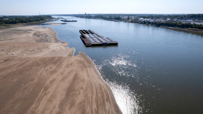 Barges float in the Mississippi River, St. Louis, Sept. 15, 2023.
