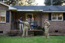 Airmen from Joint Base Charleston speak to a family living right next to the site of a crashed F-35 about the operation to recover the fighter jet and requests for the family in Williamsburg County, S.C., on Monday, Sept. 18, 2023.