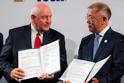 Chancellor of the University System of Georgia Sonny Perdue, left, and Hyundai Motor Group Executive Chairman Euisun Chung hold up a new memorandum of understanding for future mobility collaboration during a ceremony at Georgia Tech in Atlanta, Tuesday, Sept. 19, 2023.