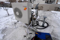 A condenser sits on the roof during the installation of a heat pump on Jan. 20, 2023, in Denver.