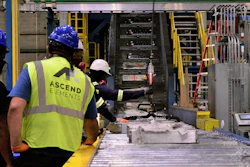 This undated photo provided by Ascend Elements shows team members loading used electric vehicle battery modules onto a massive shredder at the Ascend Elements battery recycling facility in Covington, Ga.