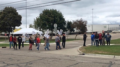 United Auto Workers picket outside the Flint Processing Center where multiple people were hit on Tuesday, Sept. 26, 2023, in Swartz Creek, Mich.