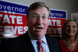 With wife Elee Reeves at his side, Mississippi Gov. Tate Reeves speaks in Jackson, Miss.