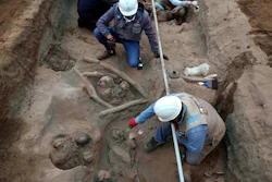 Archaeologists uncover bones and vessels discovered by city workers who were digging a natural gas line for the company Calidda in the district of Carabayllo on the outskirts of Lima, Peru, Friday, Sept. 22, 2023.