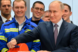 Russian President Vladimir Putin, foreground right, attends the launch ceremony for the first technological line for liquefying natural gas on gravity bases as part of the Arctic LNG2 (Liquefied Natural Gas) project at the Center for the construction of large-tonnage offshore structures (CSCMS) of Novatek-Murmansk company in the village of Belokamenka, about 1700 km (1063 miles) north of Moscow, Murmansk region, Russia, Thursday, July 20, 2023.