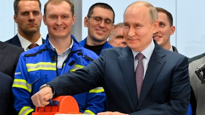 Russian President Vladimir Putin, foreground right, attends the launch ceremony for the first technological line for liquefying natural gas on gravity bases as part of the Arctic LNG2 (Liquefied Natural Gas) project at the Center for the construction of large-tonnage offshore structures (CSCMS) of Novatek-Murmansk company in the village of Belokamenka, about 1700 km (1063 miles) north of Moscow, Murmansk region, Russia, Thursday, July 20, 2023.